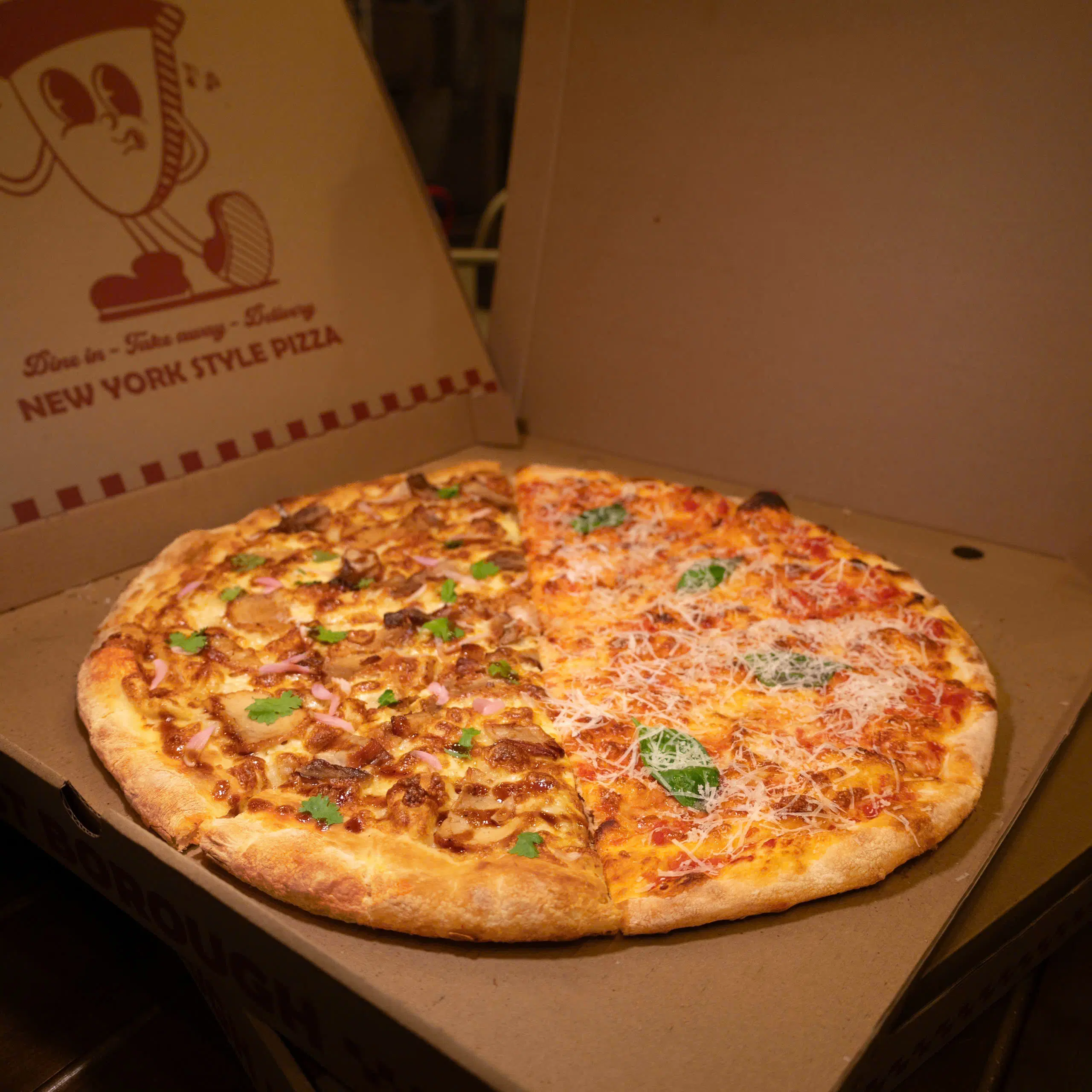 A whole East Borough pizza boxed for takeaway.